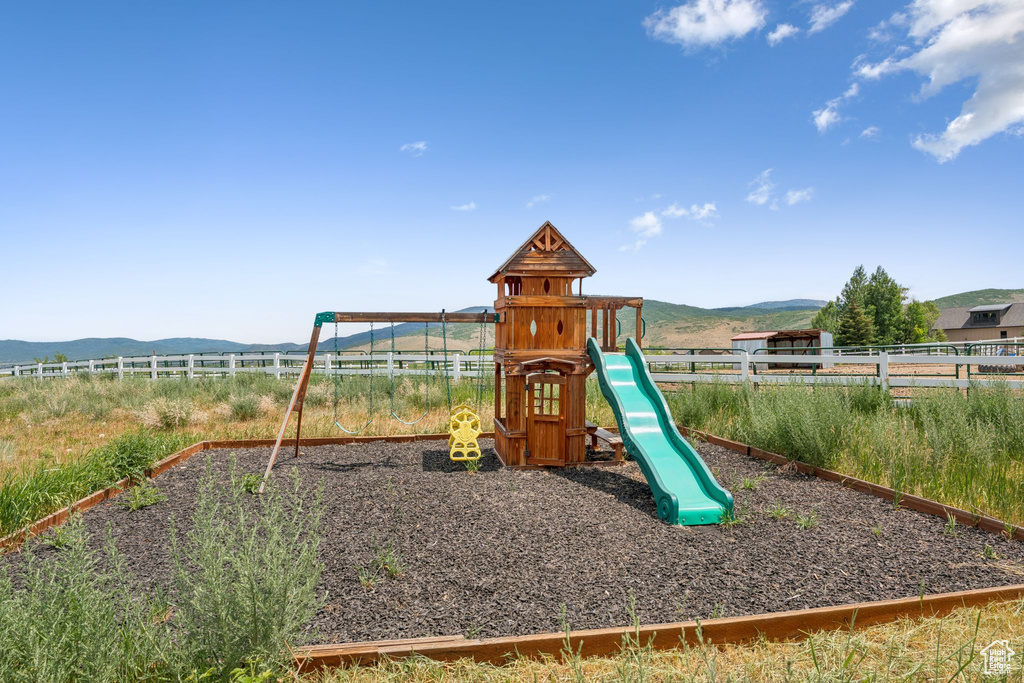 Communal playground featuring a mountain view