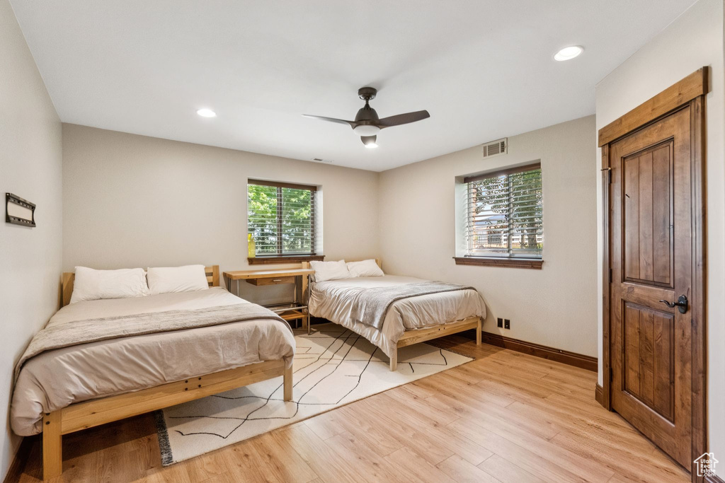 Bedroom with light wood-style floors, recessed lighting, and ceiling fan