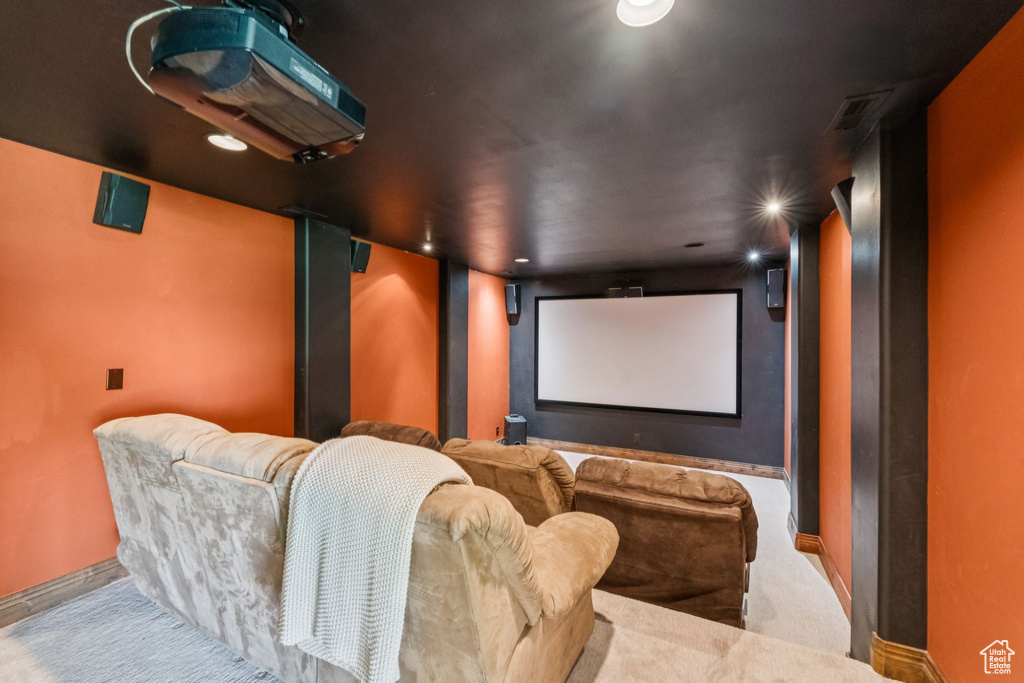 Carpeted home theater room with recessed lighting