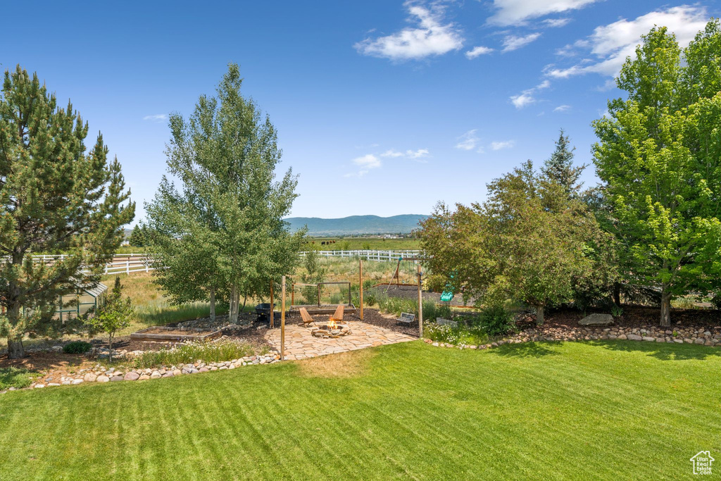 View of yard featuring a mountain view and a patio
