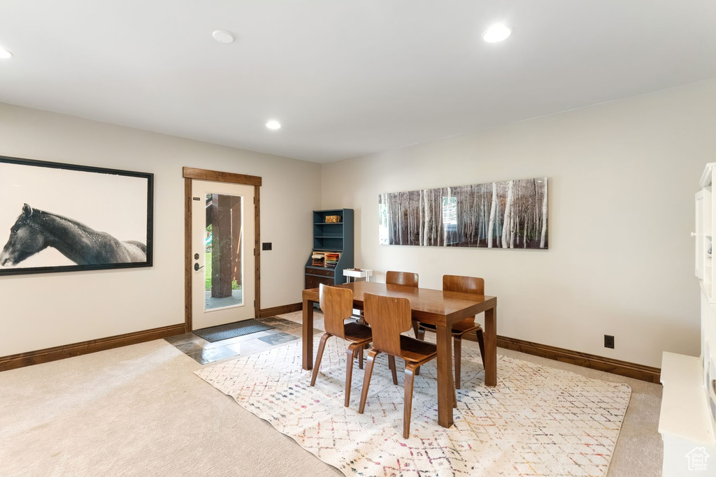 Dining area featuring recessed lighting and light carpet