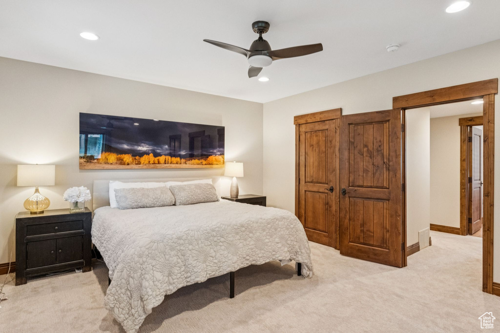 Carpeted bedroom with recessed lighting and ceiling fan