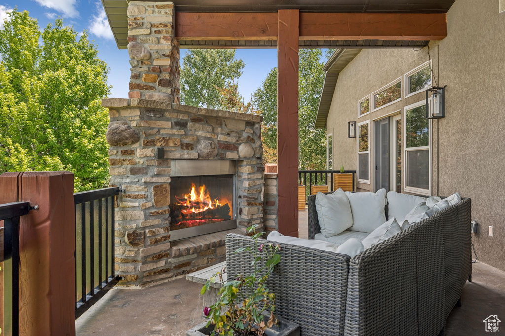 View of patio featuring an outdoor living space with a fireplace