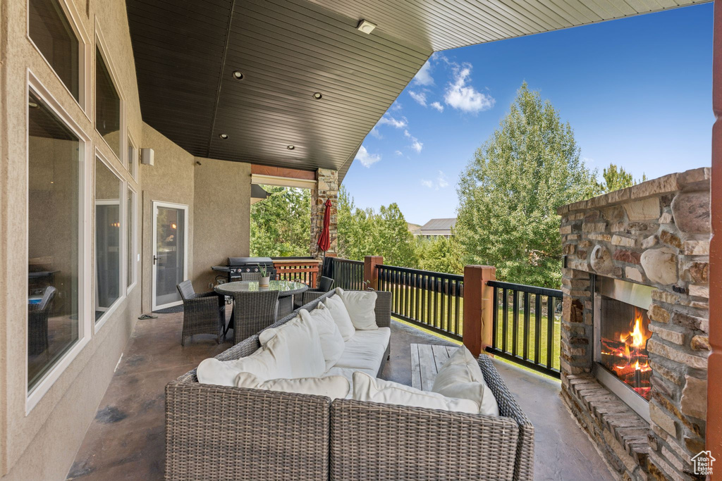 View of patio / terrace with an outdoor living space with a fireplace and outdoor dining space