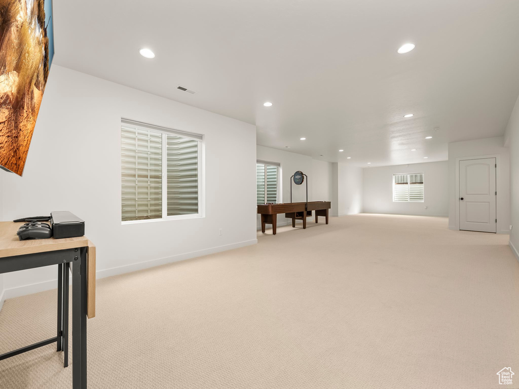 Living area featuring recessed lighting and light colored carpet
