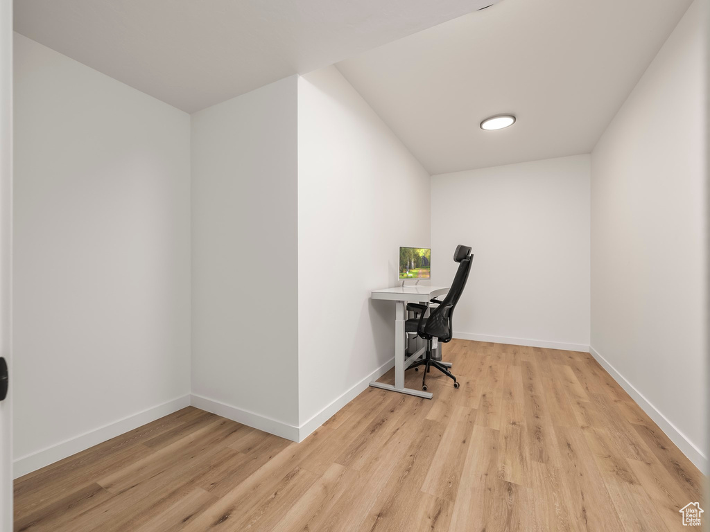 Home office with wood finished floors and baseboards