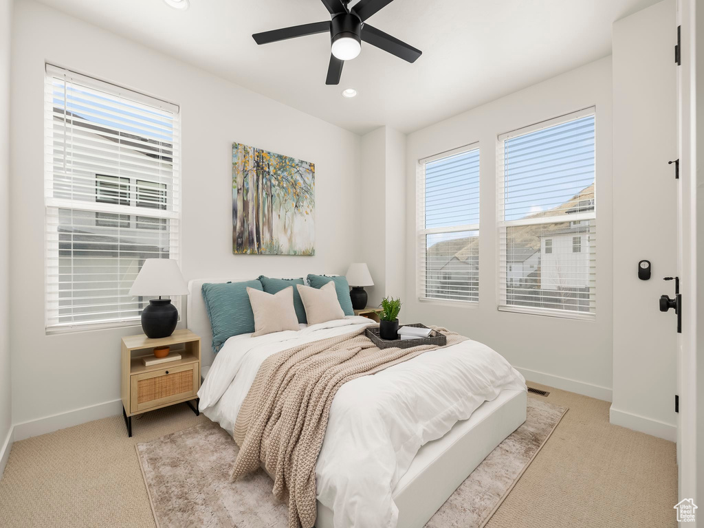 Bedroom with light carpet, recessed lighting, and a ceiling fan