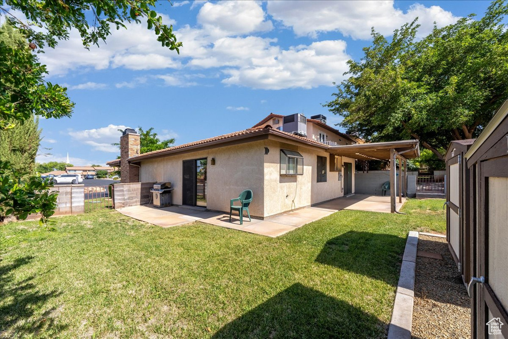 Back of property with a patio area, stucco siding, and a chimney