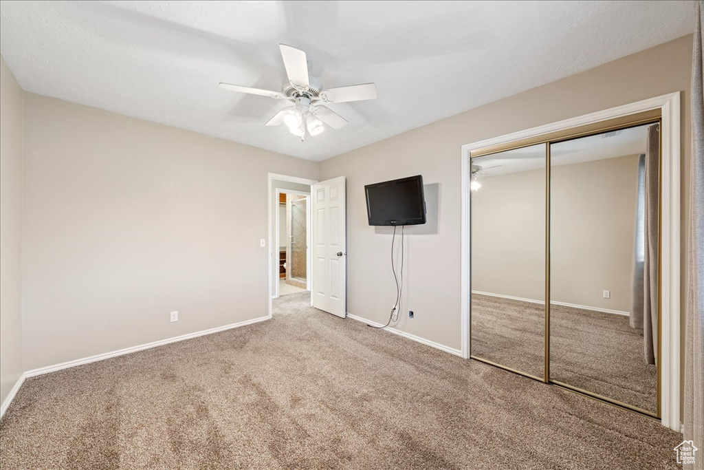 Unfurnished bedroom featuring carpet, a closet, and ceiling fan
