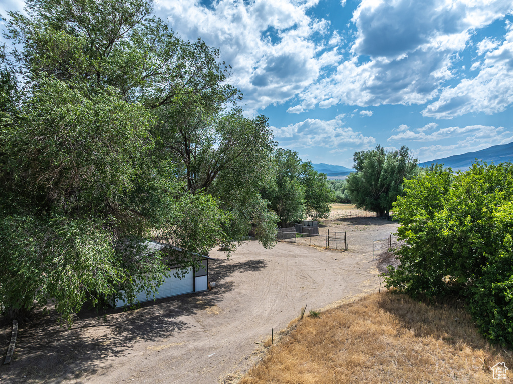 View of yard featuring a mountain view, a rural view, and an outdoor structure