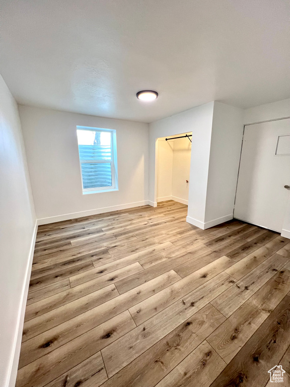 Unfurnished bedroom with light wood-type flooring and baseboards
