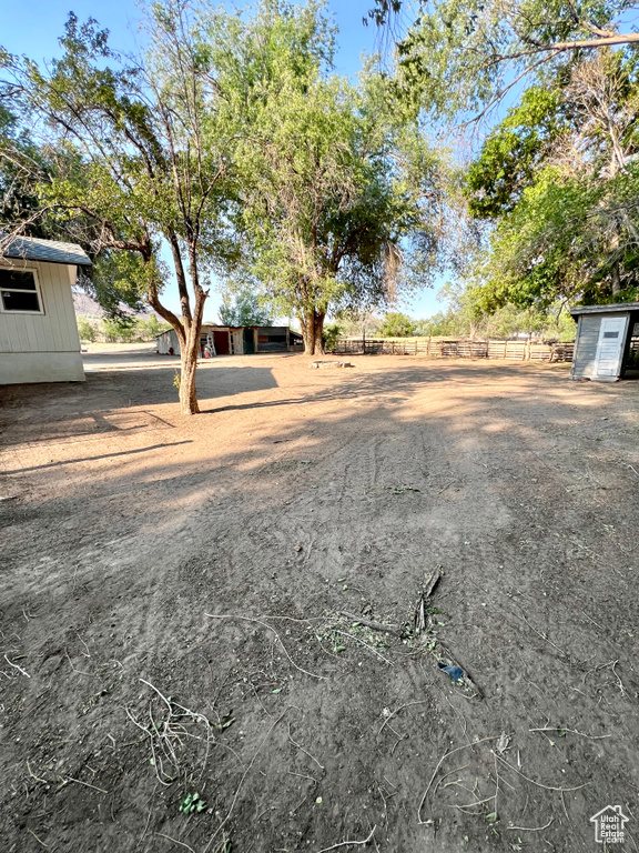 View of yard featuring a storage unit