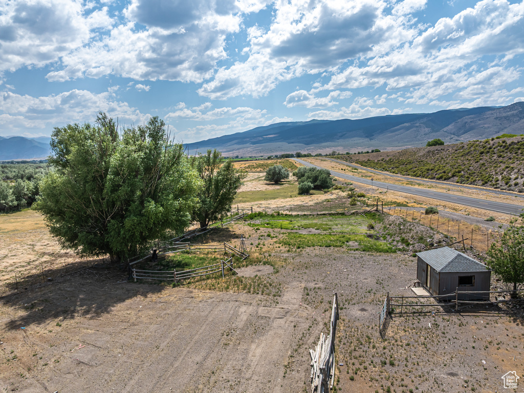 View of mountain backdrop with rural landscape