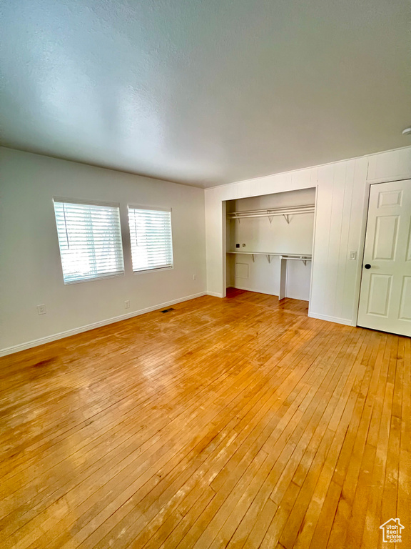 Spare room with light wood-style floors and baseboards