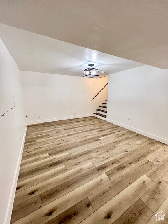 Bonus room featuring light wood-style flooring and stairs
