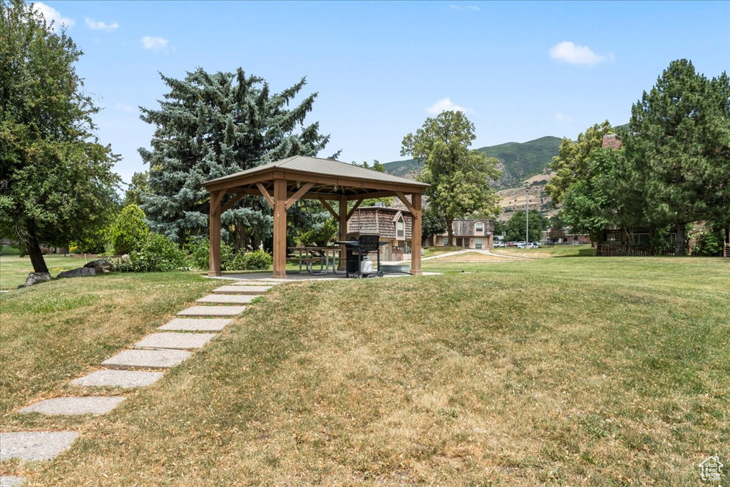View of grassy yard with a gazebo and a mountain view