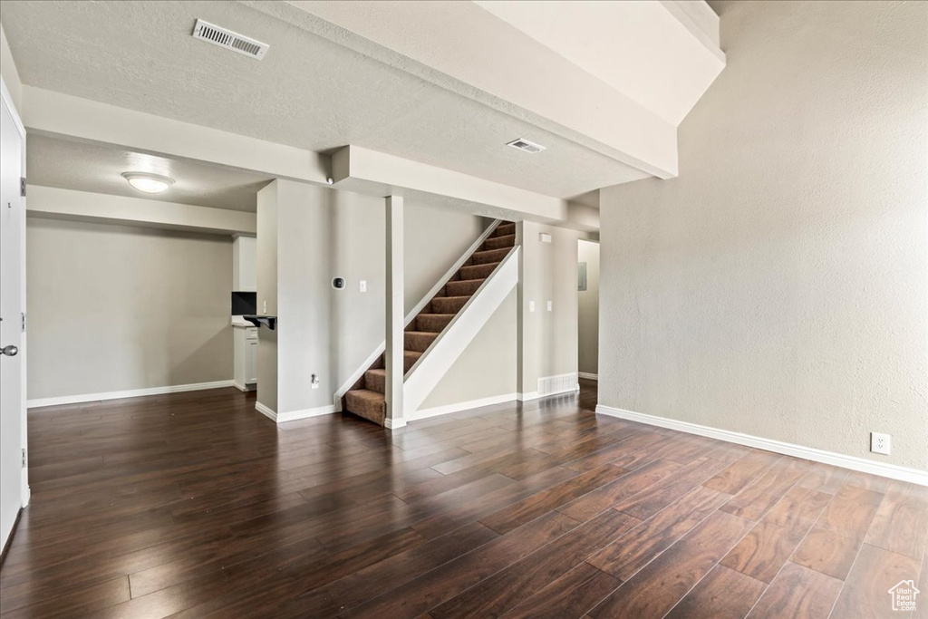 Finished below grade area with wood finished floors and stairs