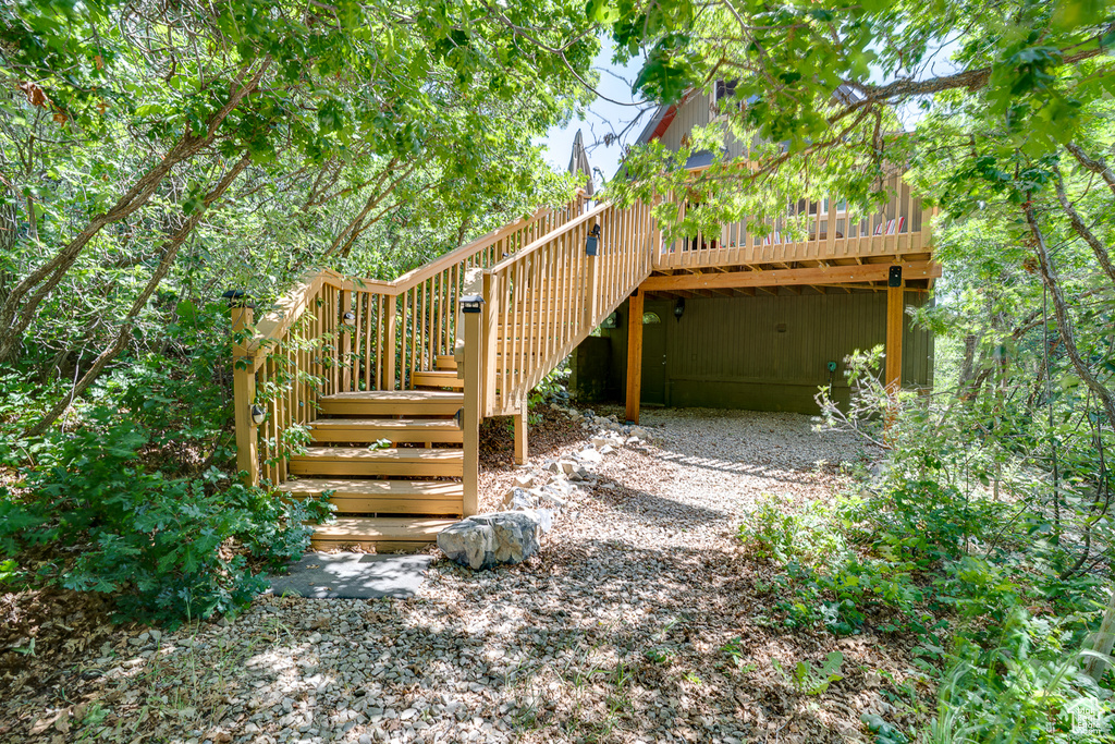 View of yard with stairs and a wooden deck