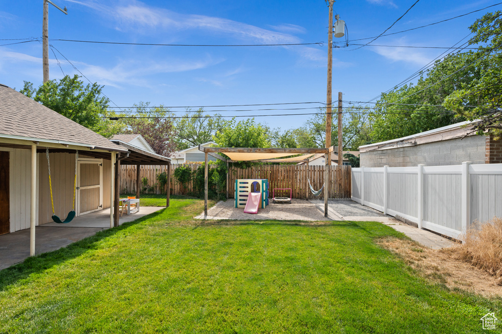 Fenced backyard with a patio area