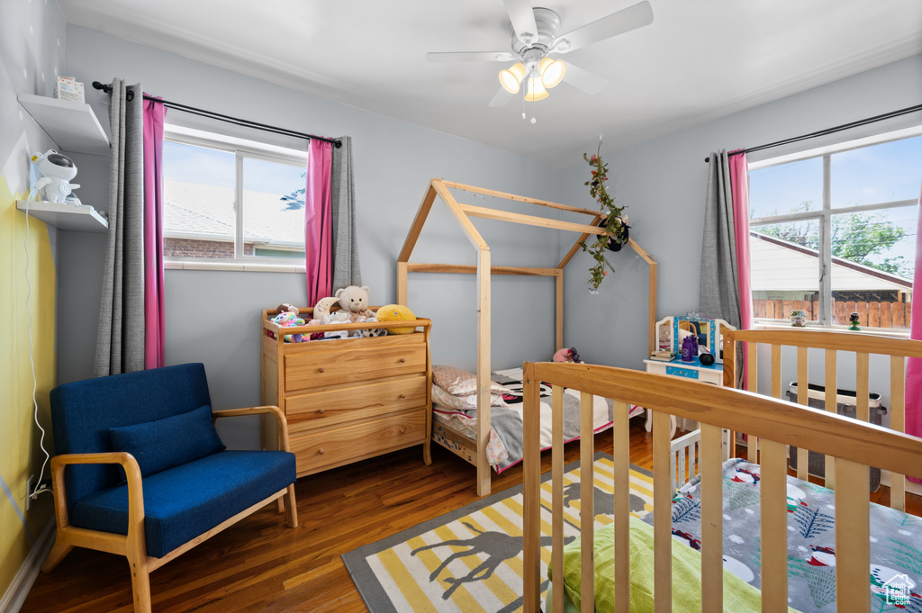Bedroom with wood finished floors and a ceiling fan
