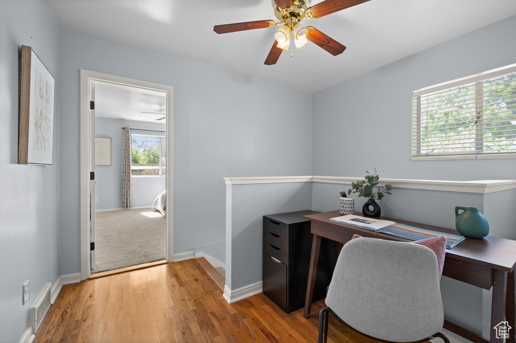 Office area with ceiling fan and wood finished floors