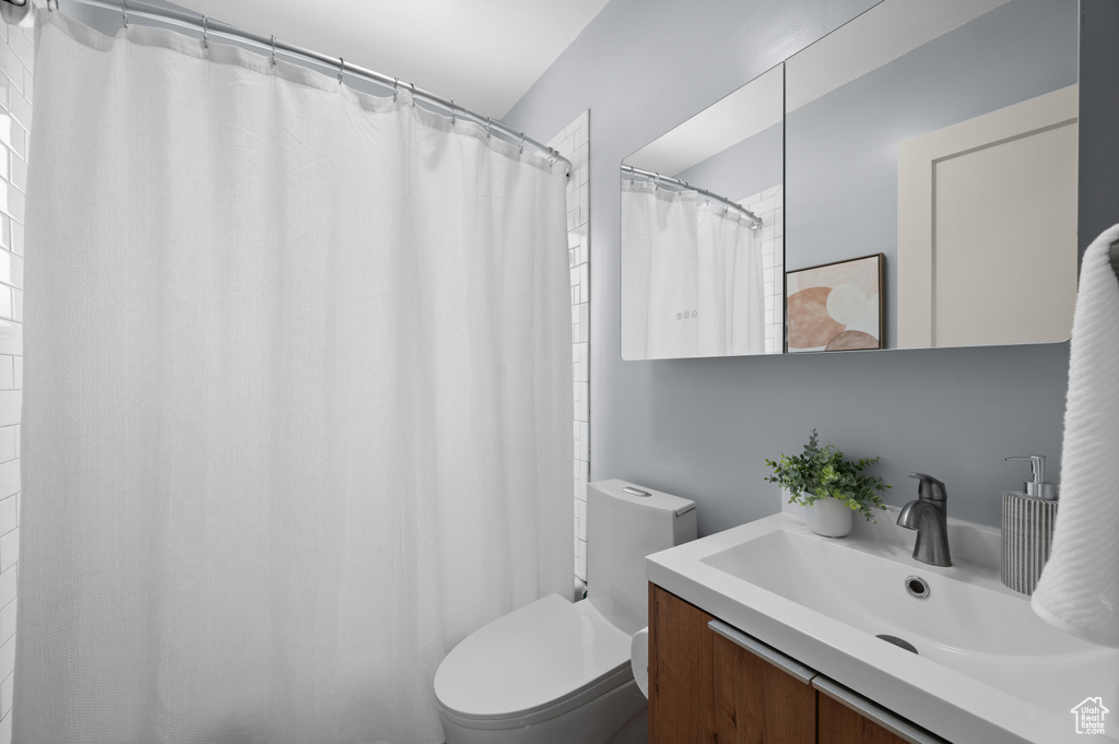 Bathroom with vanity and curtained shower