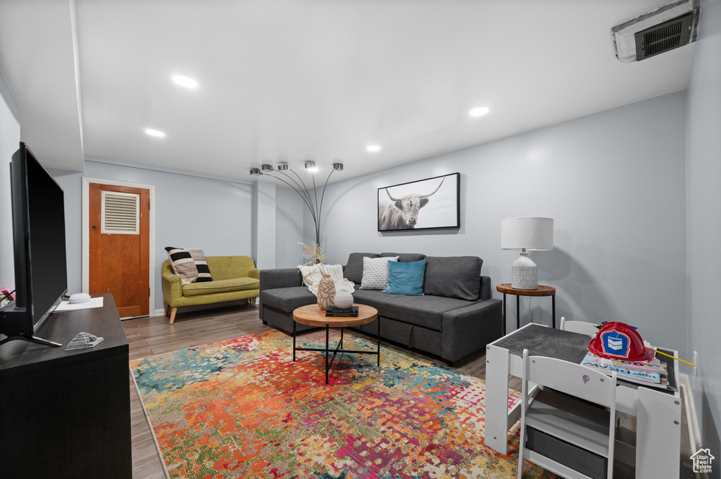 Living area featuring wood finished floors and recessed lighting