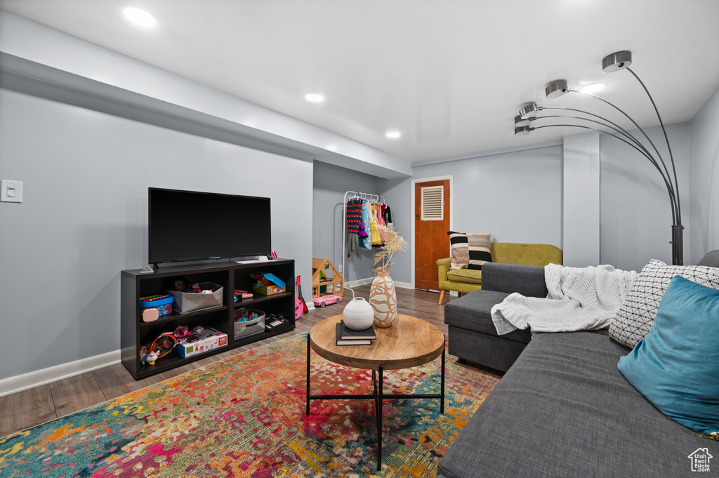 Living room featuring wood finished floors and recessed lighting