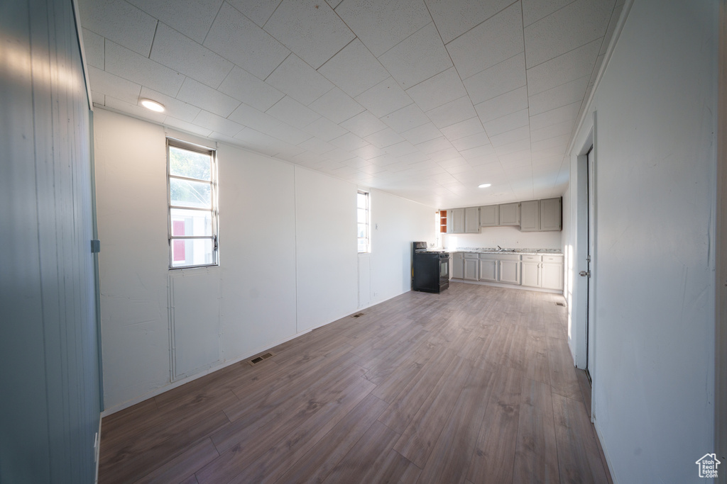 Unfurnished room with dark wood-style flooring