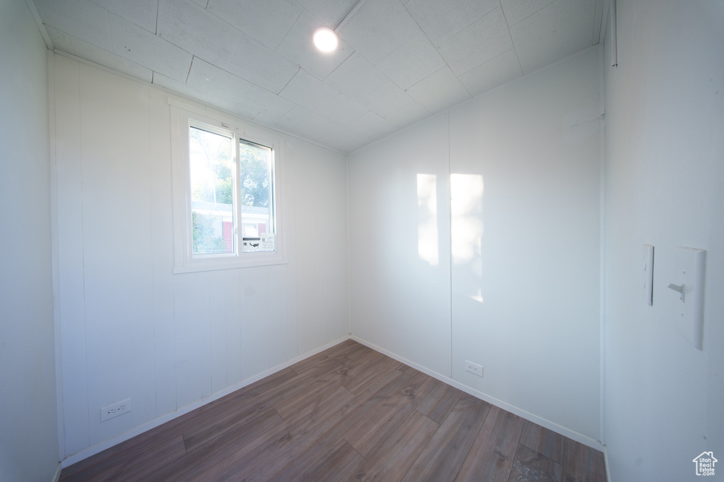 Empty room featuring wood finished floors and baseboards