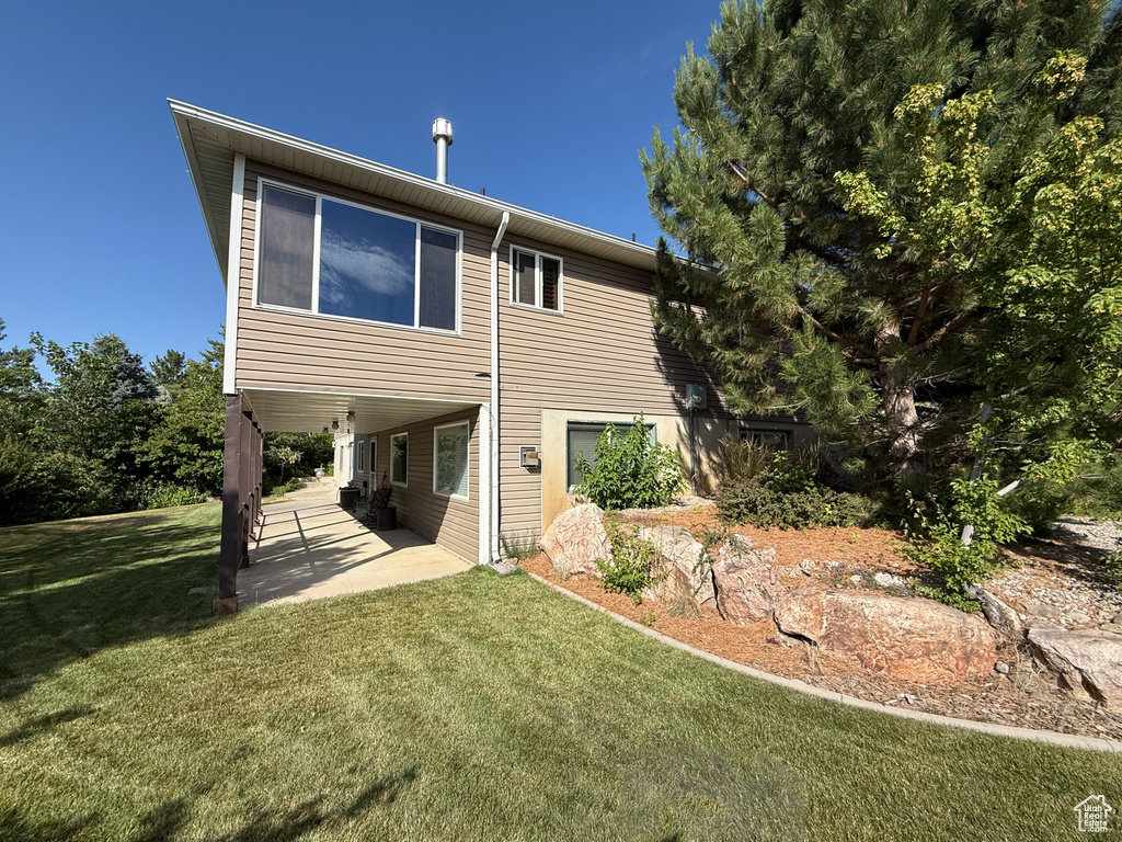 Back of house featuring a patio and a yard