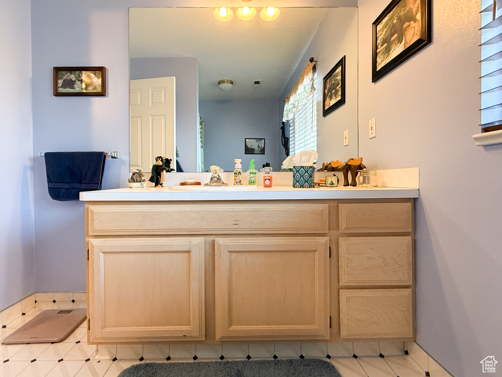Bathroom with vanity and ensuite bath