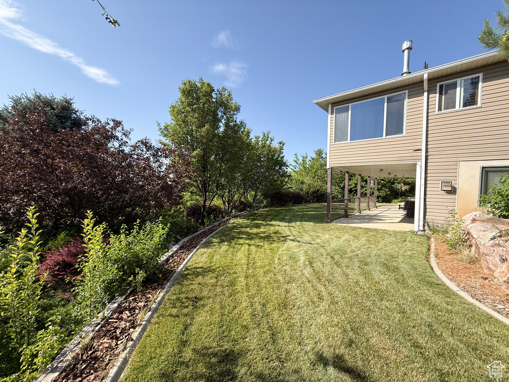 View of green lawn featuring a patio area