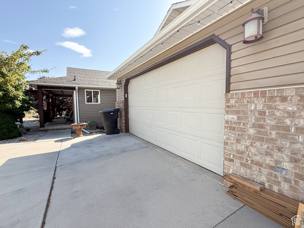Garage featuring concrete driveway