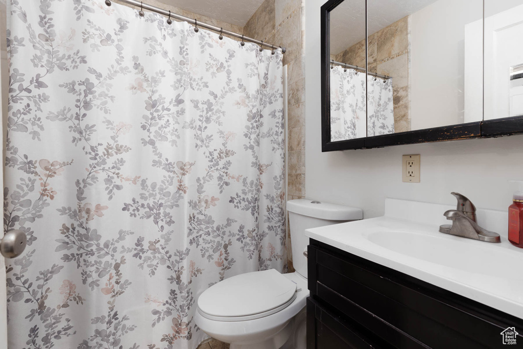 Bathroom with vanity and a shower with shower curtain