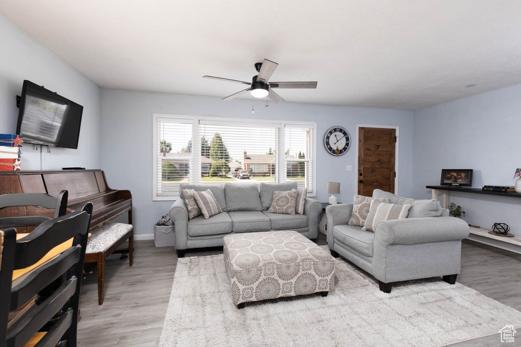 Living room with a ceiling fan and wood finished floors
