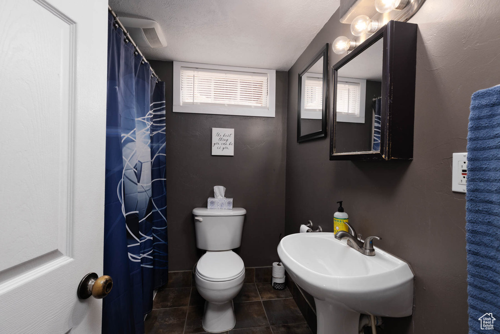 Full bathroom featuring tile patterned flooring and toilet