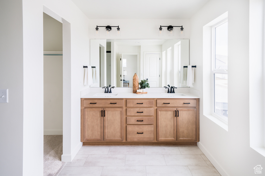 Full bath with double vanity and tile patterned floors