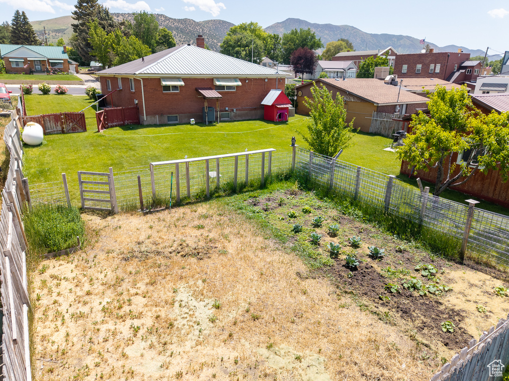 Fenced backyard featuring a mountain view