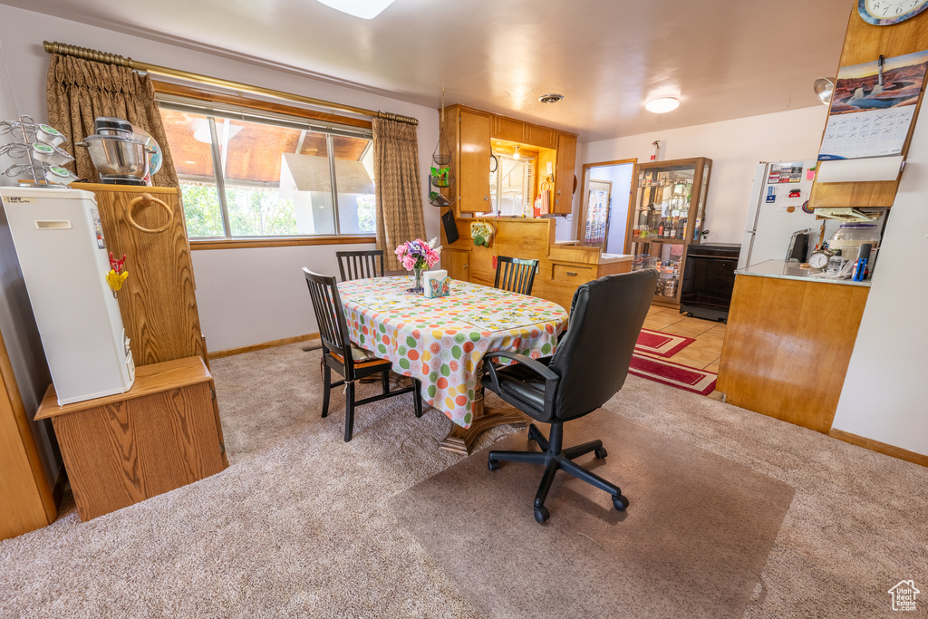 Dining room featuring light colored carpet