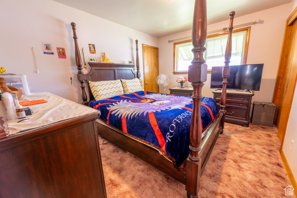 Bedroom with light colored carpet