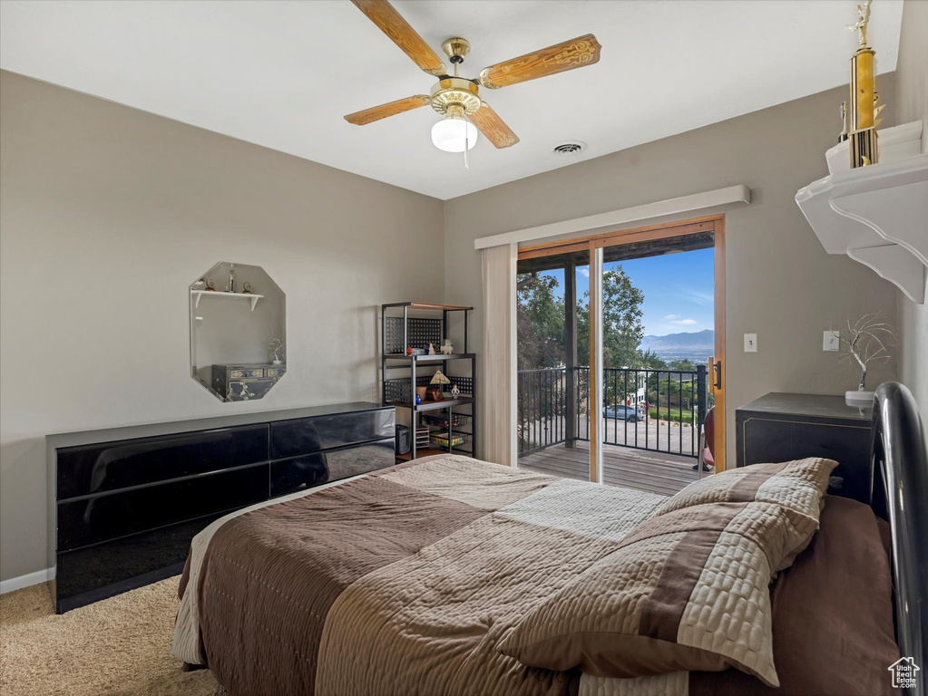 Carpeted bedroom with access to outside and a ceiling fan
