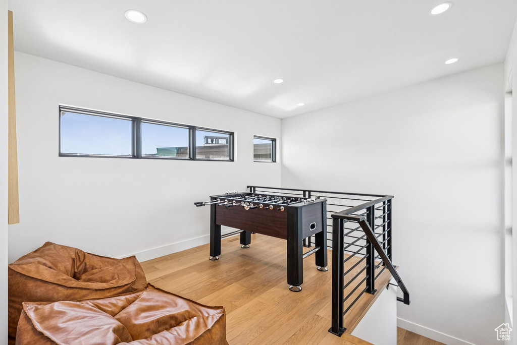 Game room with light wood finished floors and recessed lighting