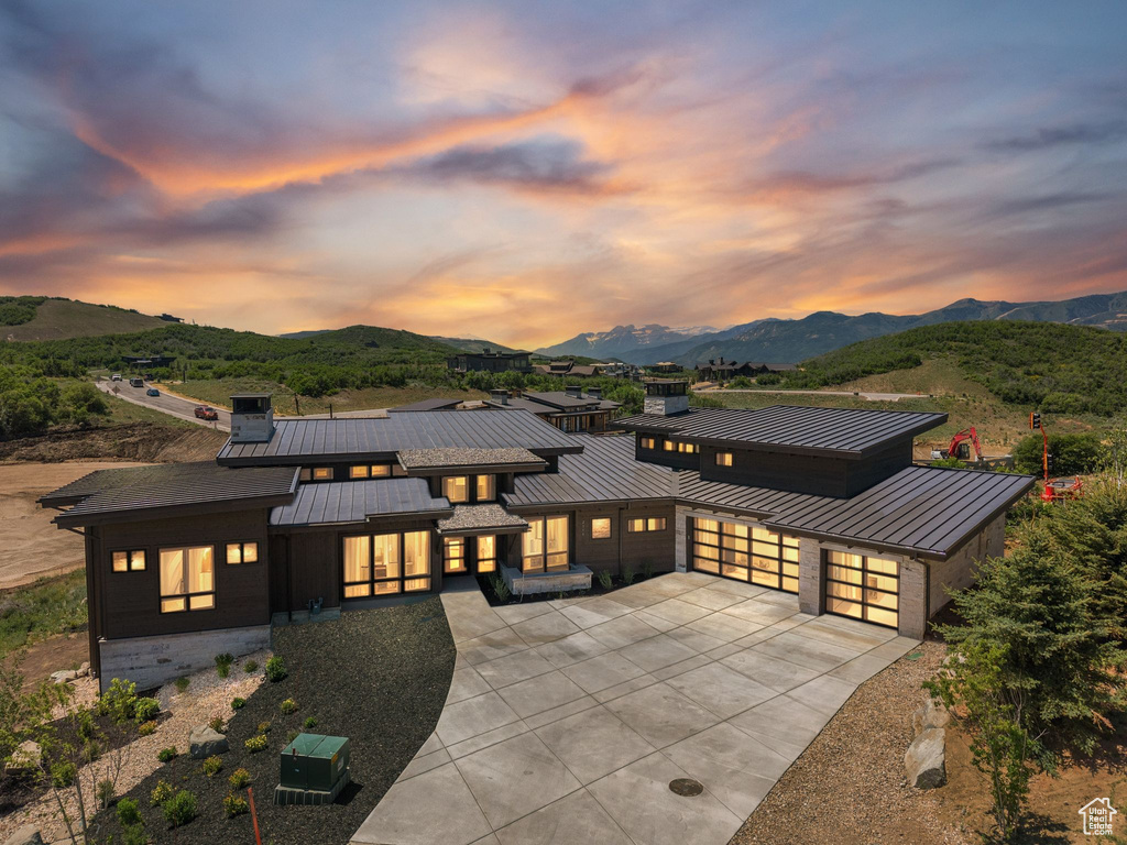View of front of home featuring a standing seam roof, a metal roof, and a mountain view