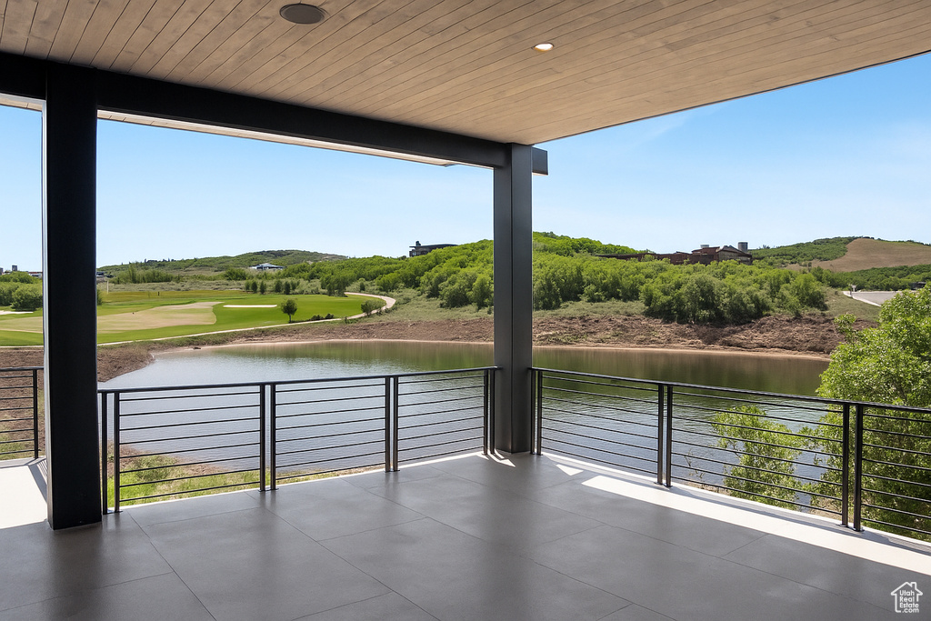 Patio / terrace featuring a water view and golf course view