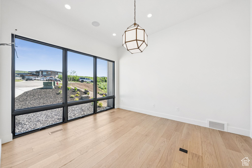 Unfurnished room featuring wood finished floors and recessed lighting