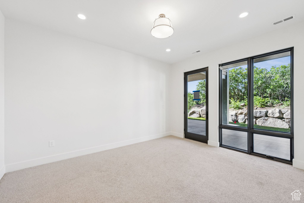 Unfurnished room with light carpet and recessed lighting