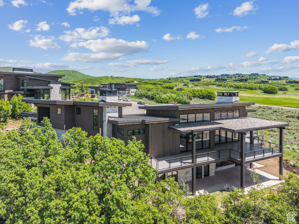 Back of property with a balcony and a mountain view
