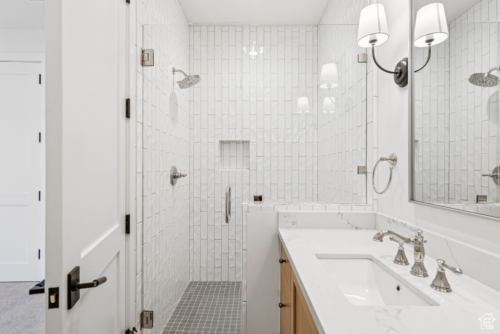 Bathroom featuring a stall shower and vanity