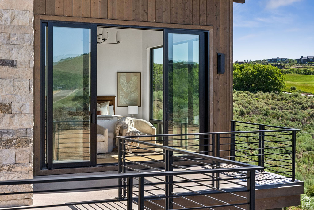 Doorway to outside featuring wood walls